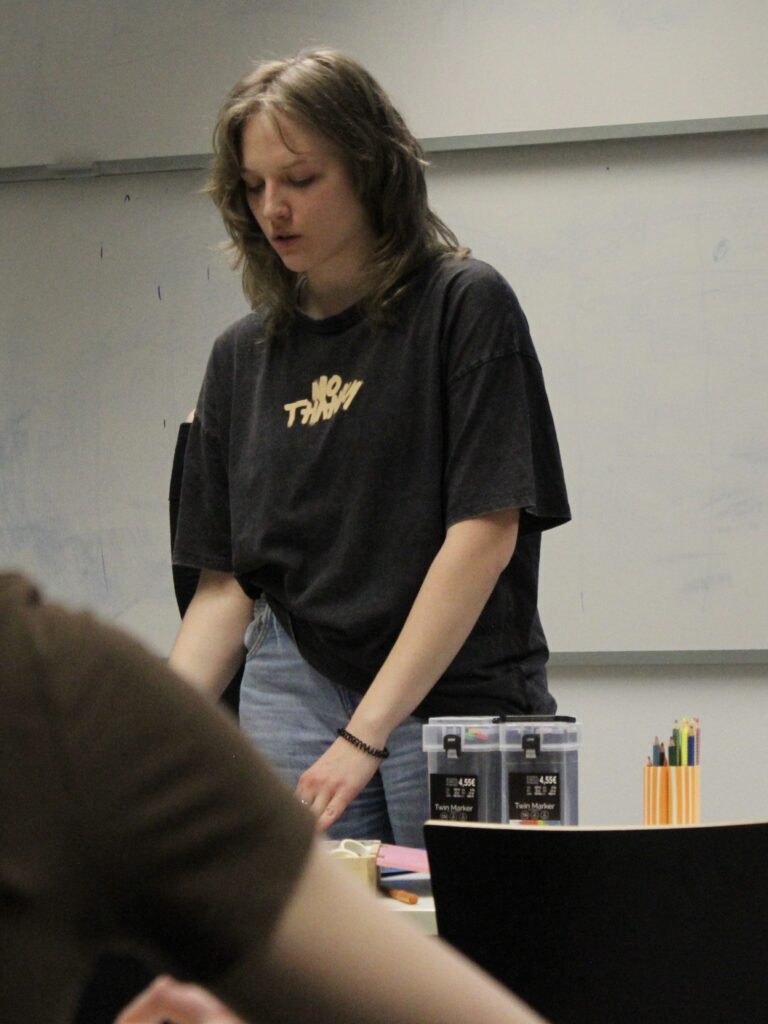 woman standing with art supplies